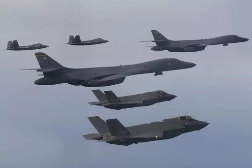 In this photo provided by South Korean Defense Ministry, U.S. Air Force B-1B bombers, center, F-22 fighter jets and South Korean Air Force F-35 fighter jets, bottom, fly over South Korea Peninsula during a joint air drill in South Korea, on Jan. 1, 2023. South Korean and U.S. militaries will hold a table-top exercise at the Pentagon next week to hone their joint response to a potential use of nuclear weapons by North Korea, Seoul officials said Friday, Feb. 17, 2023. (South Korean Defense Minist
