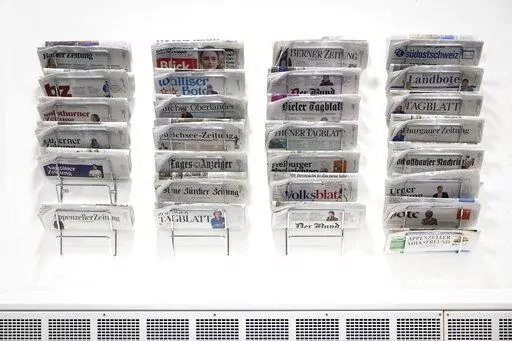 Swiss daily newspapers displayed in the Media Center of the Federal Parliament in Bern, Switzerland, Wednesday, Jan. 5, 2022. On Sunday, Feb. 13, 2022, voters in Switzerland consider on a government's public aid plan to support broadcast and print media. (Peter Klaunzer/Keystone via AP)
