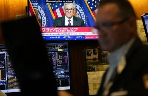 Screens display a news conference by Federal Reserve Chair Jerome Powell on the floor of the New York Stock Exchange in New York, Wednesday, Jan. 29, 2025. (AP Photo/Seth Wenig)