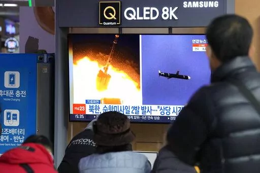 People watch a TV showing file images of North Korea's missile launch during a news program at the Seoul Railway Station in Seoul, South Korea, Tuesday, Jan. 25, 2022. North Korea on Tuesday test-fired two suspected cruise missiles in its fifth round of weapons launches this month, South Korean military officials said, as it displays its military might amid pandemic-related difficulties and a prolonged freeze in nuclear negotiations with the United States. The Korean letters read: "North Korea f