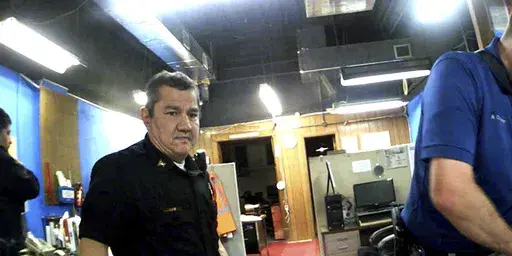 This image from Marion, Kan., Police Department body camera video provided by the McDonald Tinker law firm shows former Marion Police Chief Gideon Cody during his department's raid of the Marion County Record newspaper on Aug. 11, 2023, in Marion, Kan. (McDonald Tinker via AP)