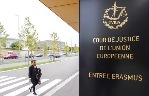 In this photo taken on Oct. 5, 2015 a woman walks by the entrance to the European Court of Justice in Luxembourg. The European Union’s top court says Google has to delete search results about people in Europe if they can prove that the information is clearly wrong. People in Europe have the right to ask search engines to delete links to outdated or embarrassing information about themselves, even if it is true, under a principle known as “right to be forgotten.” (AP Photo/Geert Vanden Wijng