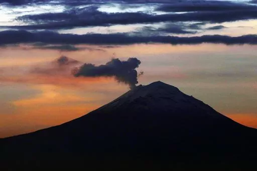 A plume of ash and steam rises from the Popocatepetl volcano, as seen from Mexico City, Wednesday, June 19, 2019. Popocatepetl rumbled to life again this third week of May 2023, spewing out towering clouds of ash that forced 11 villages to cancel school sessions. (AP Photo/Marco Ugarte, File)