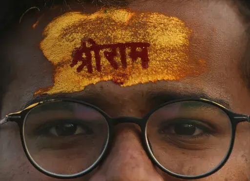 A devotee has the name of Hindu god Rama written on his forehead during a religious procession to celebrate Ram Navami, a Hindu festival marking the birth anniversary of Lord Ram, in Hyderabad, India, Sunday, April 10, 2022. India’s hardline Hindu nationalists have long espoused an anti-Muslim stance, but attacks against the minority community have recently occurred more frequently. In Madhya Pradesh state’s Khargone city, the festival turned violent after Hindu mobs brandishing swords and s