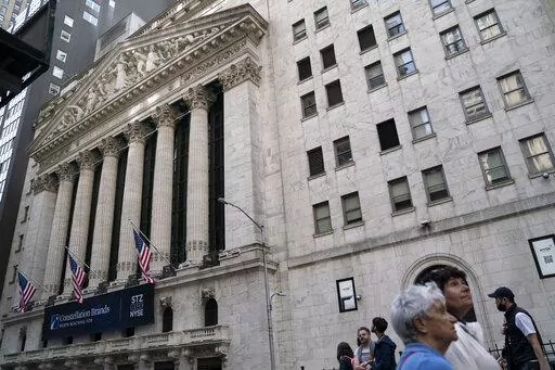 Pedestrians pass the New York Stock Exchange, May 5, 2022, in the Manhattan borough of New York. Stocks are off to a higher start on Wall Street Monday, June 6, 2022 led by more gains in big tech companies. The S&P 500 was up 0.8%. The benchmark index is coming off its eighth losing week in the last nine. The Nasdaq rose 1.2% and the Dow rose 0.5%. (AP Photo/John Minchillo, file)