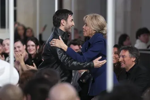 Designer Nicolas Ghesquiere, left, is congratulated by Brigitte Macron, following the Louis Vuitton Fall/Winter 2025-2026 Womenswear collection presented in Paris, Monday, March 10, 2025. (Photo by Scott A Garfitt/Invision/AP)