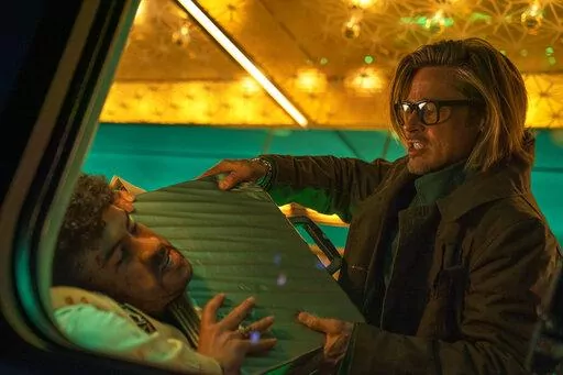 This image released by Sony Pictures shows Bad Bunny, left, and Brad Pitt in a scene from "Bullet Train." (Scott Garfield/Sony Pictures via AP)