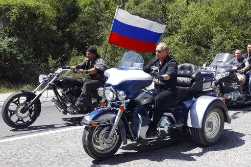 Russia's Prime Minister Vladimir Putin, foreground, rides a Harley-Davidson Lehman Trike as he arrives for the meeting with Russian and Ukrainian bikers at their camp near Sevastopol, in Ukraine's Crimea Peninsula, on July 24, 2010.  Harley-Davidson halted motorcycle shipments to Russia and said its thoughts “continue for the safety of the people of Ukraine.”. (Sergei Karpukhin/Pool Photo via AP, File)