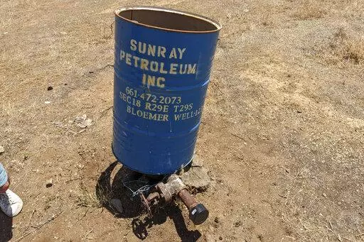 This photo provided by Clark Williams-Derry, shows a well leaking methane on May 10, 2022, in a neighborhood on the outskirts of Bakersfield, Calif. After 21 idle wells, including this one, were found to be leaking methane — some of them explosive levels of it — in May and June, the California Air Resources Board told The Associated Press that it’s not tallying leaks from idle wells. (Clark Williams-Derry via AP)