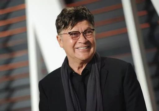 Musician Robbie Robertson arrives at the Vanity Fair Oscar Party on Sunday, Feb. 22, 2015, in Beverly Hills, Calif. Robertson, the lead guitarist and songwriter for The Band, whose classics include “The Weight,” “Up on Cripple Creek” and “The Night They Drove Old Dixie Down,” has died at 80, according to a statement from his manager. (Photo by Evan Agostini/Invision/AP, File)