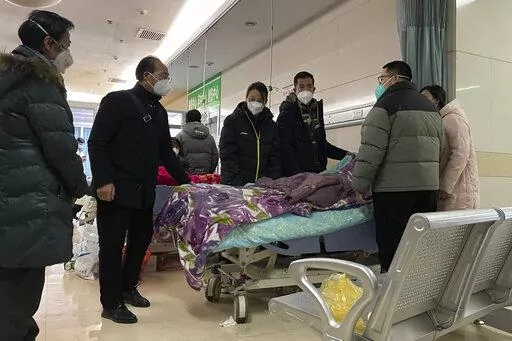 A man pulls a cloth to cover up the face of an elderly woman whose vitals flatlined as emotional relatives gather silently around her for a final farewell before her body is taken away at the emergency department of the Langfang No. 4 People's Hospital in Bazhou city in northern China's Hebei province on Thursday, Dec. 22, 2022. As China grapples with its first-ever wave of COVID mass infections, emergency wards in the towns and cities to Beijing's southwest are overwhelmed. Intensive care units