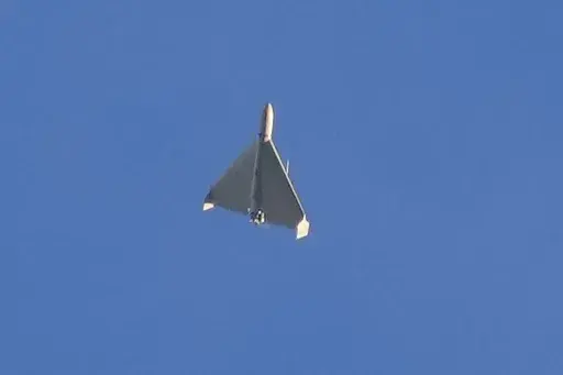 An Iranian Shahed exploding drone launched by Russia flies through the sky seconds before it struck buildings in Kyiv, Ukraine, on Oct. 17, 2022. (AP Photo/Efrem Lukatsky, File)