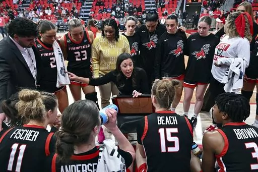 Fairfield coach Carly Thibault, center, speaks with her team during a timeout in an NCAA college basketball game, Feb. 8, 2024, in Fairfield, Conn. No. 25 Fairfield earned its first-ever ranking last week and became the eighth team to run through conference play undefeated. The Stags have a 26-game winning streak and their lone loss came to Vanderbilt, which is on the NCAA bubble. If Fairfield makes it to the final of the tournament on Saturday, March 16, 2024, and loses they might still have a 