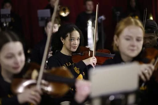 Violinist Adrianna Forbes-Dorant, 17, takes part in a rehearsal with the Brixton Chamber Orchestra for coronation weekend performances in London, Friday, April 21, 2023. Britain's diverse communities will come together to mark King Charles III's coronation. In south London's Brixton, musicians plan to parade through the streets entertaining crowds with a carnival set mix of Gospel, jazz, grime, disco and rap. In west London's Southall, known as “Little India,” British Indians will party with