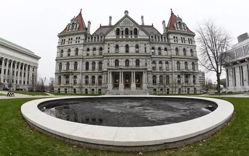 The New York state Capitol in Albany, N.Y., is pictured on Dec. 14, 2020. New York's minimum-wage workers had more than just the new year to celebrate Monday, Jan. 1, 2024, with a pay bump kicking in as the clock ticked over to 2024. In the first of a series of annual increases slated for the Empire State, the minimum wage increased to $16 in New York City and some of its suburbs, up from $15. In the rest of the state, the new minimum wage is $15, up from $14.20. (AP Photo/Hans Pennink, File)