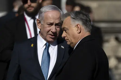 Israeli Prime Minister Benjamin Netanyahu, left, and Hungarian Prime Minister Viktor Orban, right, talk after a welcoming ceremony with a guard of honor at Buda Castle in Budapest, Hungary, on Thursday, April 3, 2025. (AP Photo/Denes Erdos)