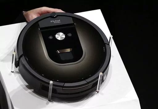 A Roomba 980 vacuum cleaning robot is presented during a presentation  in Tokyo, Tuesday, Sept. 29, 2015. Amazon on Friday, Aug. 5, 2022, announced it has entered into an agreement to acquire the vacuum cleaner maker iRobot for approximately $1.66 billion. The company sells its robots worldwide and is most famous for the circular-shaped Roomba vacuum.  (AP Photo/Eugene Hoshiko)