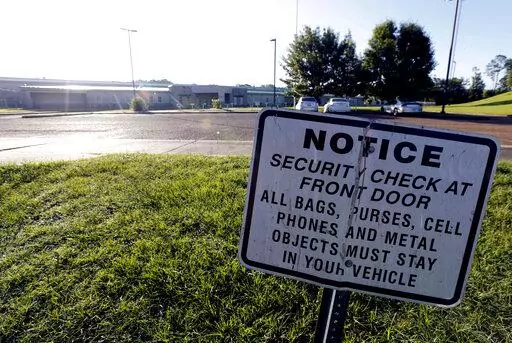A security notice is posted outside the Hinds County Detention Center in Raymond, Miss., on June 12, 2015. A federal judge has issued a civil contempt order over conditions at the detention center.  U.S. District Judge Carlton Reeves wrote Friday, Feb. 4, 2022, that Hinds County officials have failed to fix problems in the jail that has experienced violence and lax security.  (AP Photo/Rogelio V. Solis, File)