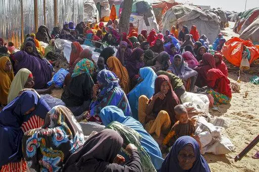 Somalis who fled drought-stricken areas sit at a makeshift camp on the outskirts of the capital Mogadishu, Somalia on Feb. 4, 2022. Two U.N. food agencies issued stark warnings on Monday, June 6, 2022 about multiple, looming food crises on the planet, driven by climate “shocks” like drought and worsened by the repercussions of the COVID-19 pandemic and the war in Ukraine that have sent fuel and food prices soaring. (AP Photo/Farah Abdi Warsameh, File)