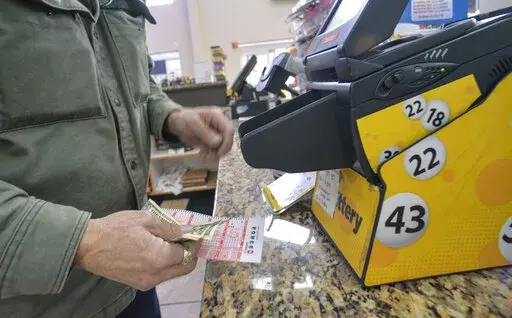 Bruce Gideos, floor manager at Pierre's Place, in Chesterfield, N.H., prints out Powerball tickets on Thursday, Nov. 3, 2022. The Powerball jackpot climbed over $1.5 billion on Thursday after no one won Wednesday's drawing. (Kristopher Radder/The Brattleboro Reformer via AP)
