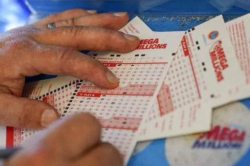 In this July 26, 2022 file photo, Gordon Midvale fills out a lottery ticket inside a 7-Eleven store in Oakland, Calif. The Mega Millions lottery jackpot has topped $1 billion — only the fourth time a lottery game has reached such heights. (AP Photo/Godofredo A. Vásquez, File)