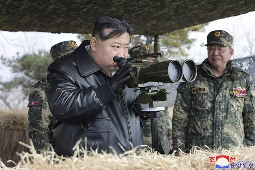 In this photo provided by the North Korean government, North Korean leader Kim Jong Un, left, supervises artillery firing drills in North Korea Thursday, March 7, 2024. Independent journalists were not given access to cover the event depicted in this image distributed by the North Korean government. The content of this image is as provided and cannot be independently verified. Korean language watermark on image as provided by source reads: "KCNA" which is the abbreviation for Korean Central News