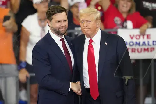 Republican vice presidential candidate Sen. JD Vance, R-Ohio, left, and Republican presidential candidate former President Donald Trump, shake hands at a campaign rally in Atlanta, Aug. 3, 2024. (AP Photo/Ben Gray, File)