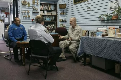 Police talks to Zein Ramawi, right, leader of the Islamic Society of Bay Ridge mosque, at An-Noor Social Center on Friday, Oct. 13, 2023, in the Brooklyn borough of New York. In Muslim communities across the world, worshippers gathered at mosques for their first Friday prayers since Hamas militants attacked Israel, igniting the latest Israel-Palestinian war. (AP Photo/Andres Kudacki)