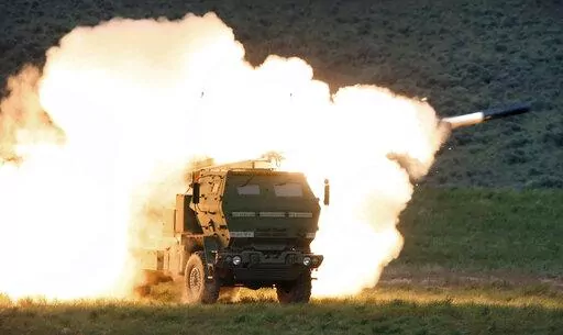 In this May 23, 2011, file photo a launch truck fires the High Mobility Artillery Rocket System (HIMARS) produced by Lockheed Martin during combat training in the high desert of the Yakima Training Center, Wash. The Biden administration is expected to announce it will send Ukraine a small number of high-tech, medium range rocket systems, U.S. officials said Tuesday. One official said the plan is to send Ukraine the HIMARS. (Tony Overman/The Olympian via AP, File)