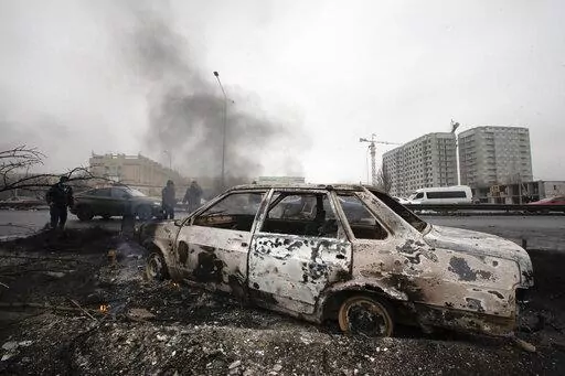 A car, which was burned after clashes, is seen on a street in Almaty, Kazakhstan, Friday, Jan. 7, 2022. Kazakhstan's president authorized security forces on Friday to shoot to kill those participating in unrest, opening the door for a dramatic escalation in a crackdown on anti-government protests that have turned violent. The Central Asian nation this week experienced its worst street protests since gaining independence from the Soviet Union three decades ago, and dozens have been killed in the 