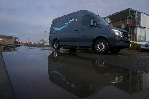 An Amazon Prime truck drives in Pacifica, Calif., on Dec. 15, 2020. Amazon has begun mass layoffs in its corporate ranks, becoming the latest tech company to trim its workforce amid rising fears about the wider economic environment. (AP Photo/Jeff Chiu, File)