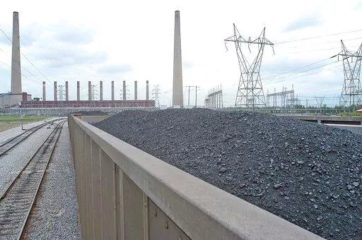 Coal is shown inside one of the train cars headed for the dumping area of the Shawnee Fossil Plant in western McCracken County, Ky. The nation's largest public utility has proposed building a $216 million solar farm project in Kentucky atop a capped coal ash storage pit at one of its coal-fired power plants. The federal Tennessee Valley Authority voted Thursday, Nov. 10, 2022 to advance the initiative at Shawnee Fossil Plant in Paducah. (John Wright/The Paducah Sun via AP)