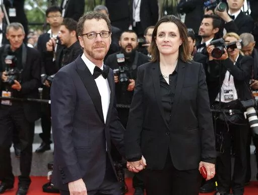 Ethan Coen, left, and Tricia Cooke at the 68th international film festival, Cannes, southern France, Saturday, May 23, 2015. Most in the film industry thought Ethan Coen was done with movies. Ethan did, too. But on Sunday, Coen will premiere his first documentary, "Jerry Lee Lewis: Trouble in Mind," at the Cannes Film Festival. (AP Photo/Lionel Cironneau, File)