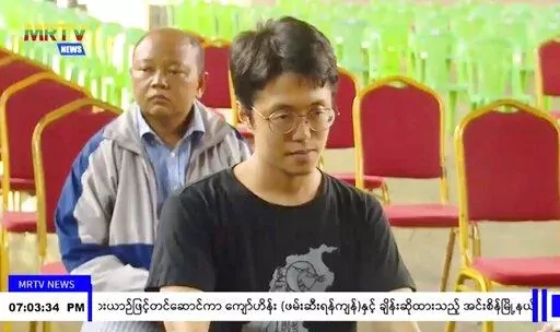 In this image taken from video by Myanmar state broadcaster MRTV, Japanese national Toru Kubota is shown seated during a ceremony inside the Insein prison in Yangon, Myanmar on Thursday, Nov. 17, 2022. Myanmar’s military-controlled government says it is releasing and deporting an Australian academic, a Japanese filmmaker, an ex-British diplomat and an American as part of a broad prisoner amnesty marking the country’s National Victory Day. (MRTV via AP)