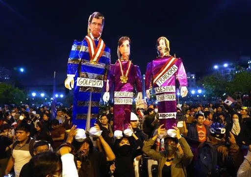 Supporters of ousted Peruvian President Pedro Castillo hold puppets depicting President of Congress Jose Williams, from left, Attorney General Patricia Benavides and Peru's new President Dina Boluarte, during a protest in Lima, Peru, Thursday, Dec. 15, 2022. A Peruvian judge on Thursday ordered Castillo to remain in custody for 18 months, approving a request from authorities for time to build their rebellion case against him. (AP Photo/Martin Mejia)