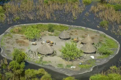 Thatched huts surrounded by floodwaters are seen from the air in Old Fangak county in Jonglei state, South Sudan on Nov. 27, 2020. A petition to stop the revival of the 118-year-old Jonglei Canal project in South Sudan, started by one of the country's top academics, is gaining traction in the country, with the waterway touted as a catastrophic environmental and social disaster for the country's Sudd wetlands. (AP Photo/Maura Ajak, File)