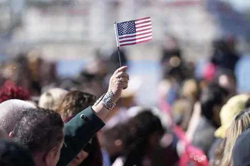 People recite an oath during a naturalization ceremony Wednesday, Feb. 15, 2023, in San Diego. Population estimates released Thursday, June 22, 2023, by the U.S. Census Bureau show what drove changes in different race and ethnic groups last year, as well as since the start of COVID-19's spread in the U.S. in April 2020. The United States had grown to 333.2 million people by the middle of last year, a 0.4% increase over the previous year, according to the 2022 population estimates. (AP Photo/Greg