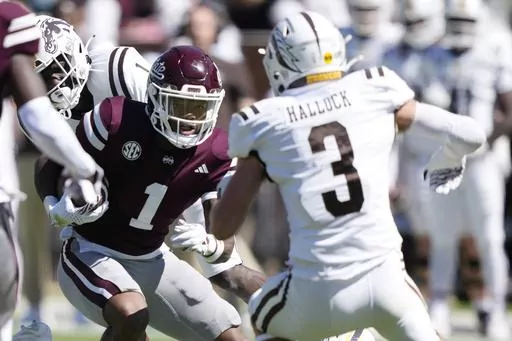Mississippi State wide receiver Zavion Thomas (1) takes a pass upfield for a first down against Western Michigan safety Tate Hallock (3) during the second half of an NCAA college football game, Saturday, Oct. 7, 2023, in Starkville, Miss. Mississippi State won 41-28. (AP Photo/Rogelio V. Solis)