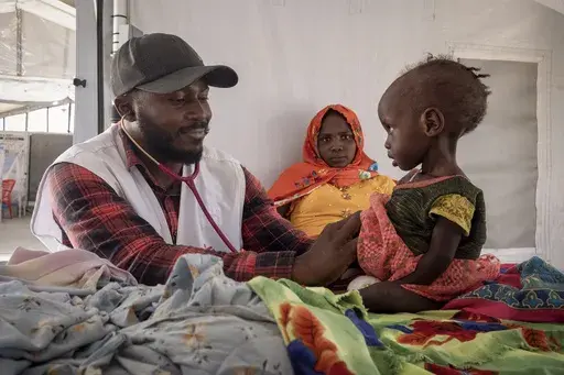 A doctor treats a Sudanese child suffering from malnutrition are treated at an MSF clinic in Metche Camp, Chad, near the Sudanese border, on April 6, 2024. (AP Photo/Patricia Simon, File)