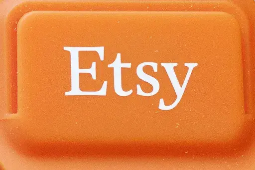 The Etsy logo is appears on a mobile credit card reader, on Jan. 6, 2015 in New York. Etsy said on Wednesday, July 31, 2024, it will begin testing its first-ever loyalty program in September, a move designed to boost sluggish sales and draw in infrequent shoppers. (AP Photo/Mark Lennihan, File)