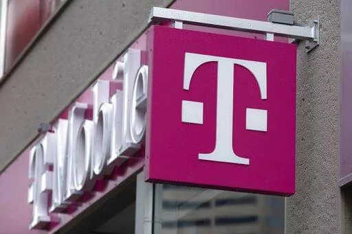 The T-Mobile logo is seen on a storefront, on Oct. 14, 2022, in Boston. Customers of the wireless provider reported widespread service outages in the U.S. late Monday, Feb. 13, 2023, according to websites tracking service interruptions. (AP Photo/Michael Dwyer, File)